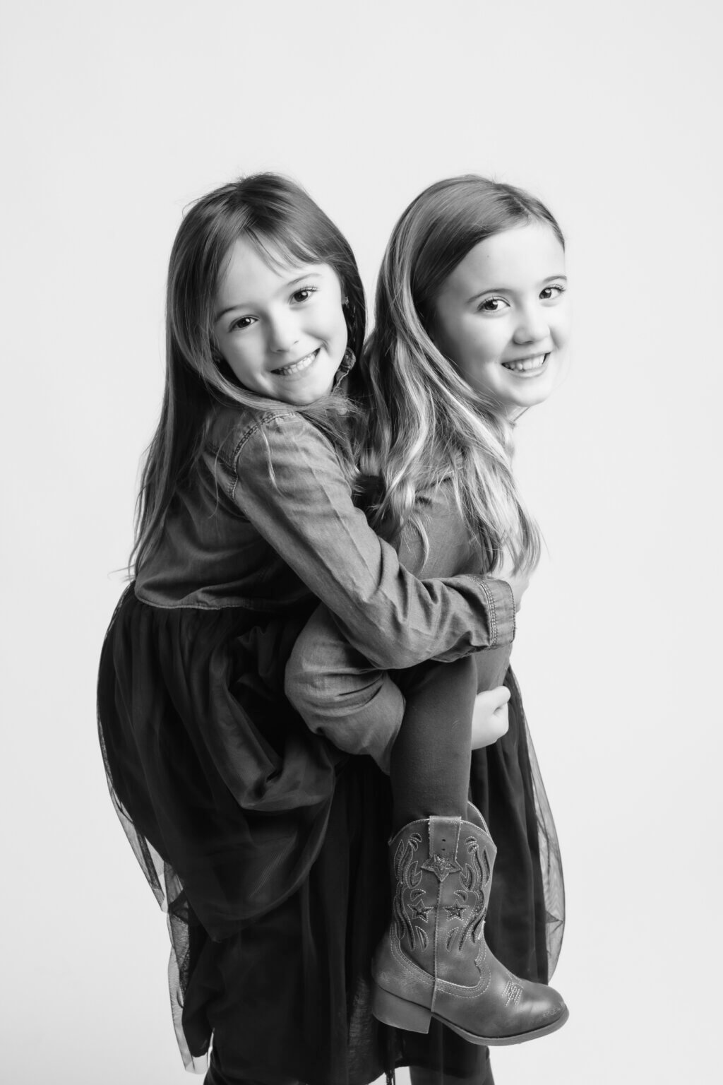 black and white family portraits of 2 sisters