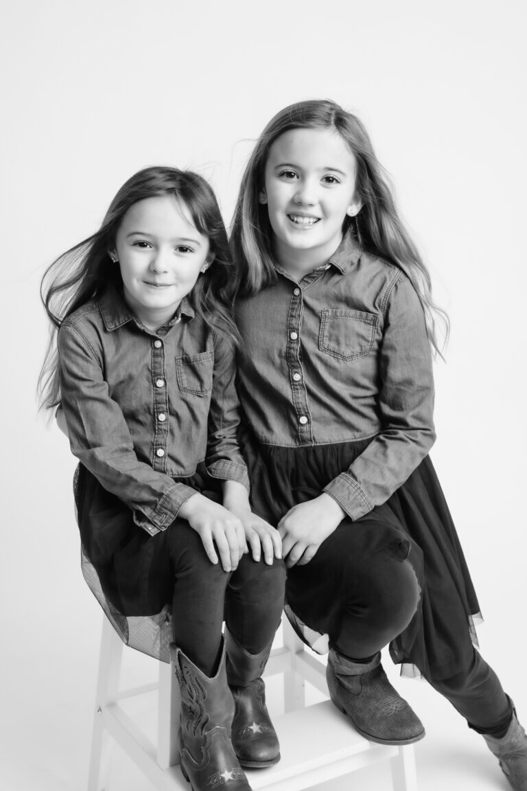 black and white family portraits of 2 sisters