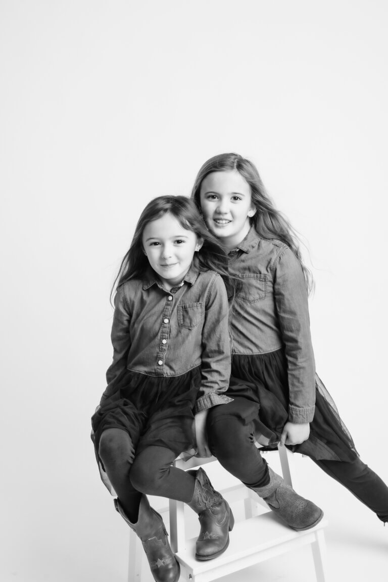 black and white family portraits of 2 sisters