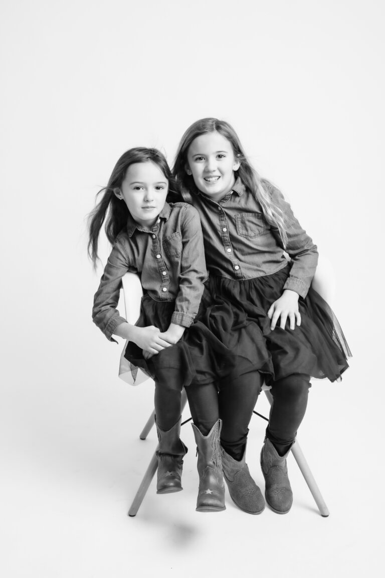 black and white family portraits of 2 sisters