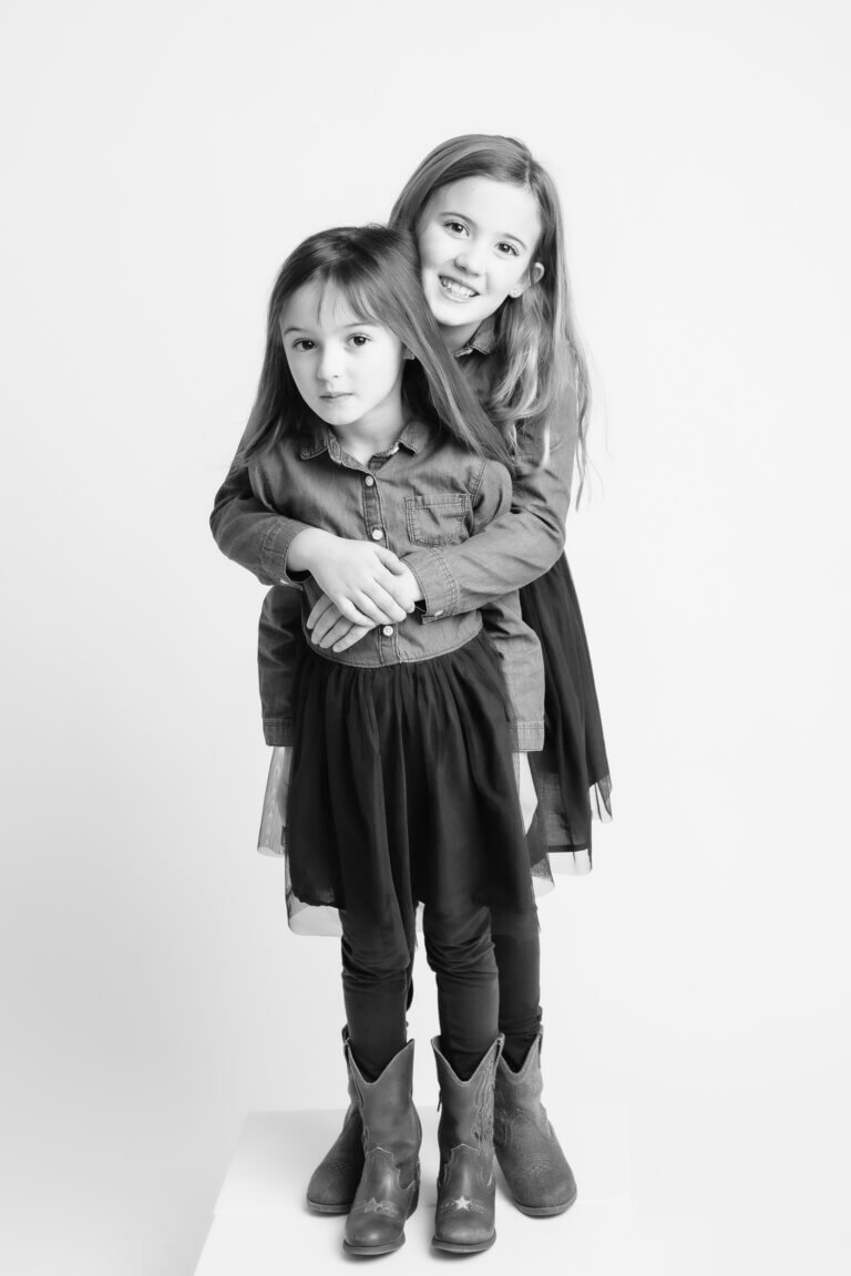 black and white family portraits of 2 sisters
