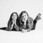 black and white family portraits of 2 sisters