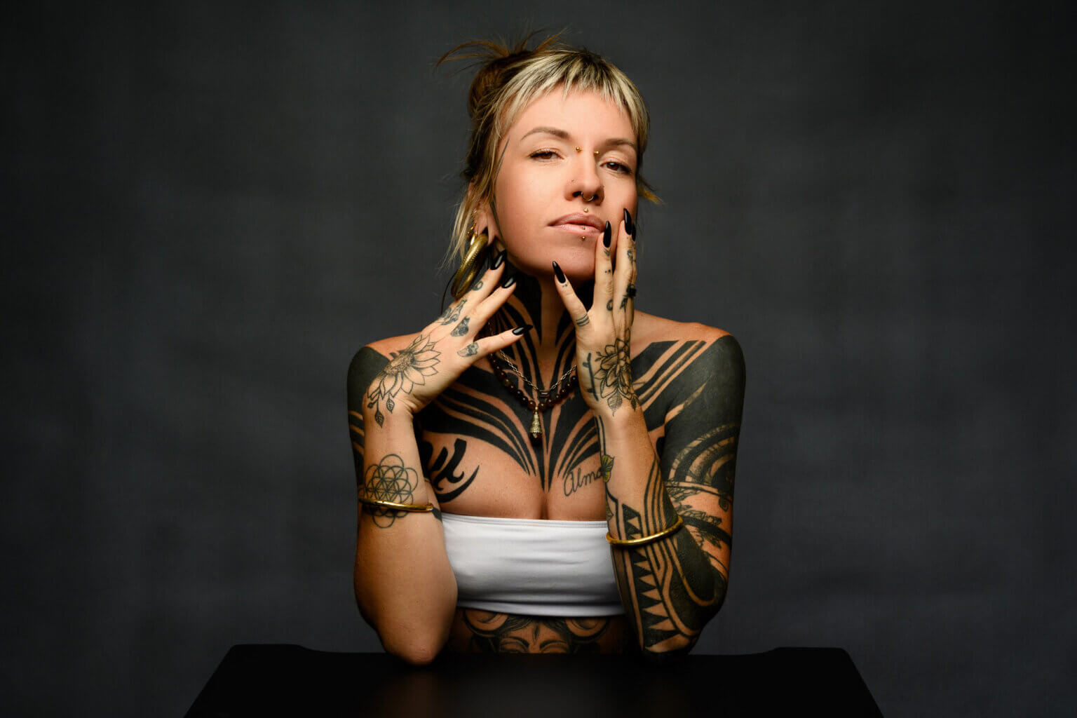 Studio creative photo shoot powerful woman with tattoos